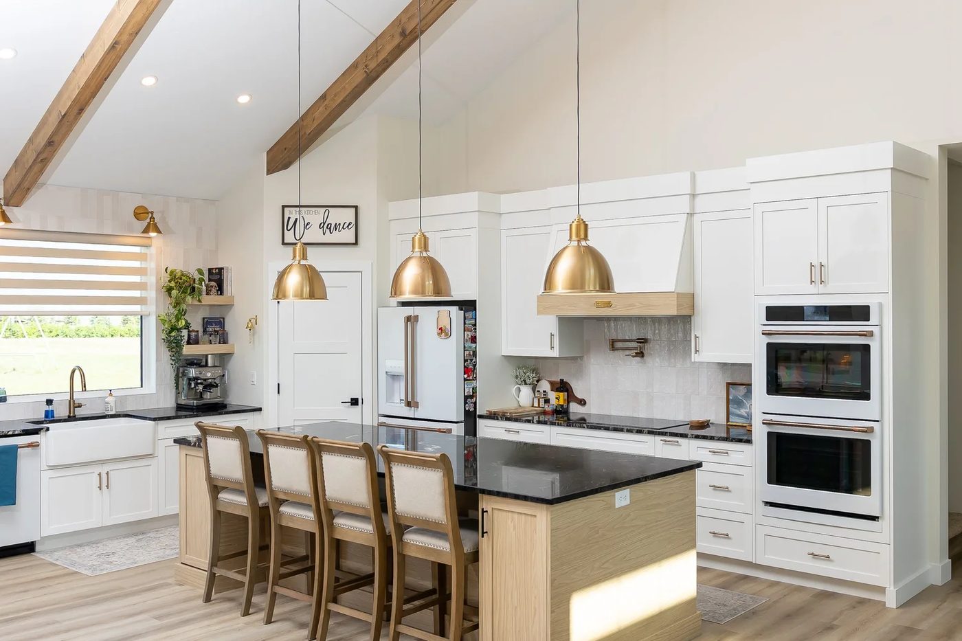 White kitchen with island seating and wood accents