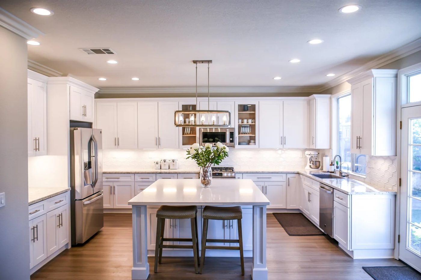 Open kitchen with white cabinets and wood island